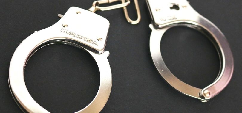 A pair of silver handcuffs.