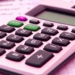 A calculator sitting atop loan documents.