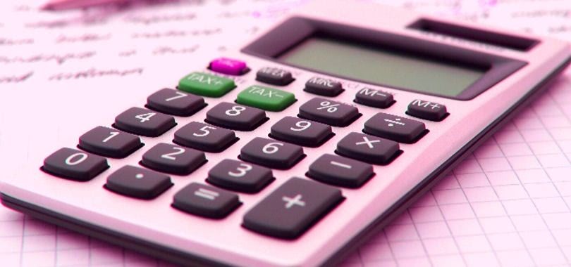 A calculator sitting atop loan documents.