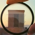 Magnifying glass over college building.