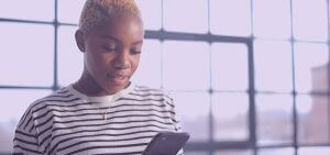 A college student applying for a stimulus check on her phone.