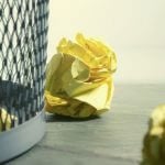 Balled up tests thrown into a wastebasket.