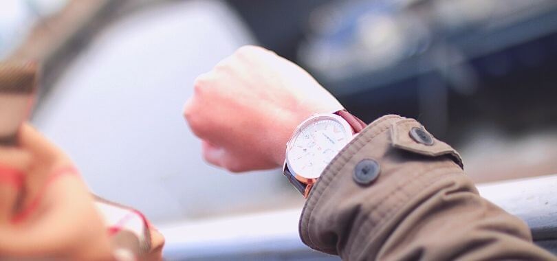 College student looking at her watch