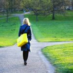 A student at a crossroads on a college campus.