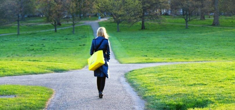 A student at a crossroads on a college campus.