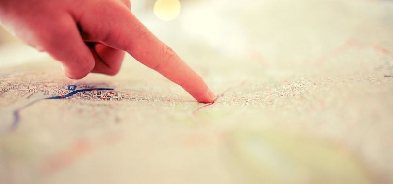 Student picking a college on a map