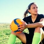 High school student playing soccer as an extracurricular activity