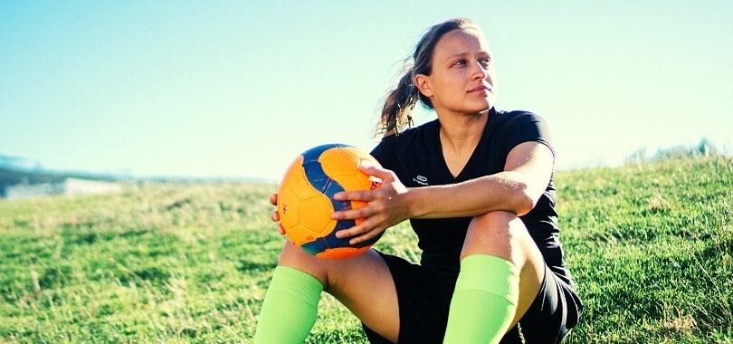 High school student playing soccer as an extracurricular activity