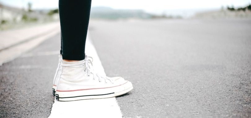 Student standing on finish line