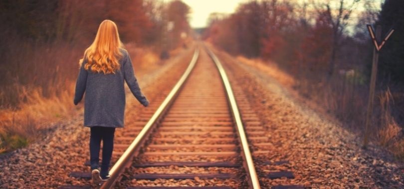 College student on train tracks