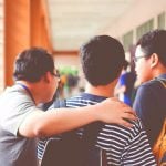 Three high school friends discuss college acceptance odds.