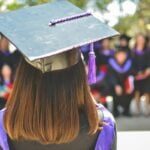 Graduate giving speech at ceremony.