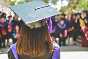 Graduate giving speech at ceremony.