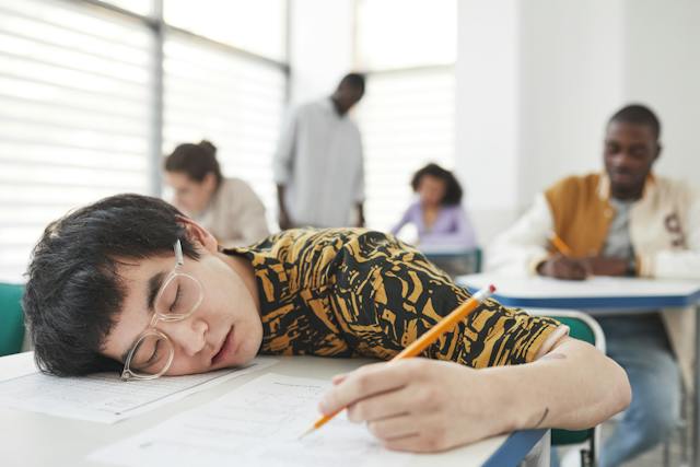 Tired student sleeping during 8 am classes